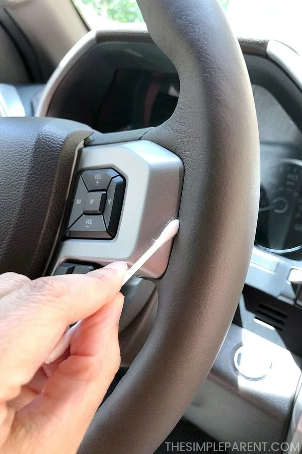 Cleaning a steering wheel with a swab